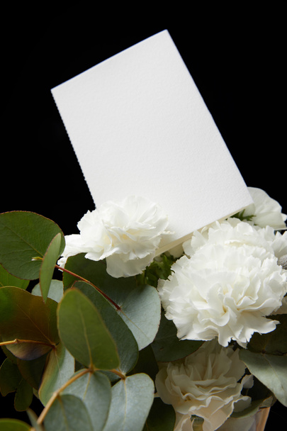 Empty card in flower bouquet isolated on black - Photo, Image