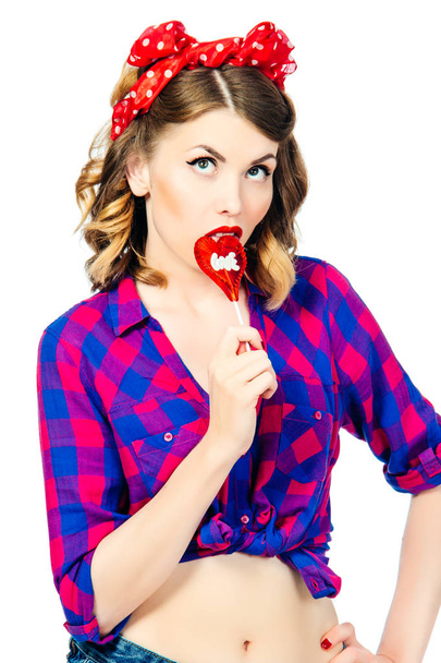 Portrait of beautiful young woman with vintage make-up and hairstyle with lollipop - 写真・画像