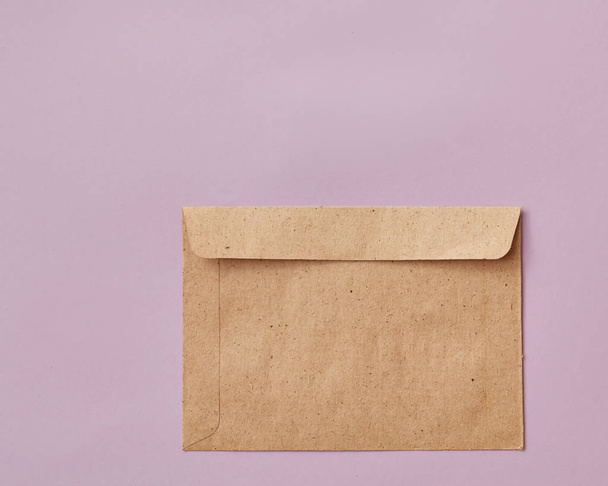 Wedding, birthday or Valentine craft paper envelope with copy space on pink background - Fotografie, Obrázek