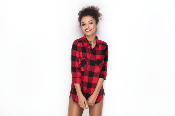 Happy afro girl in red checkered shirt. - Foto, afbeelding
