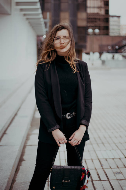 outdoor portrait of beautiful girl wearing black clothes - Photo, Image