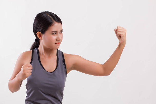 strong fitness woman punching isolated - Foto, imagen