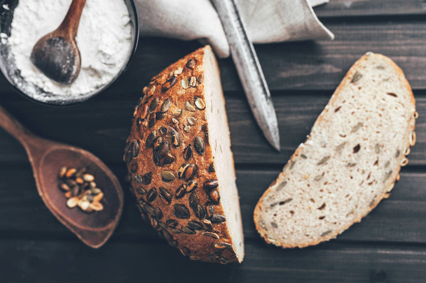Delicious fresh bread on wooden background - Фото, зображення