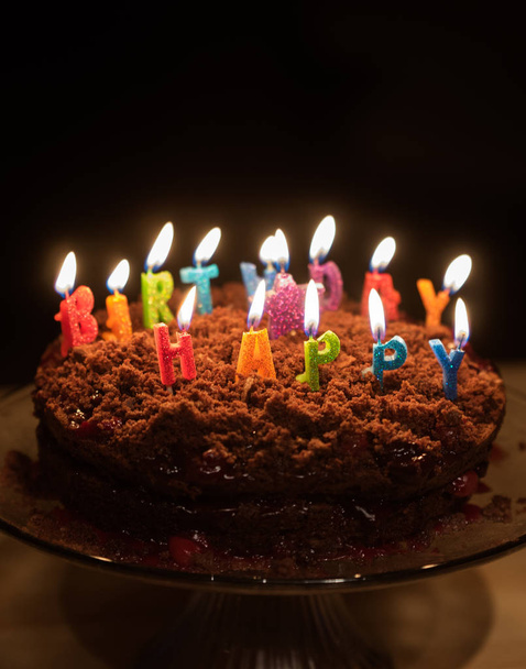Chocolate birthday cake with candles on it - Fotoğraf, Görsel