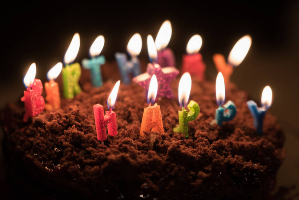 Chocolate birthday cake with candles on it - Foto, imagen