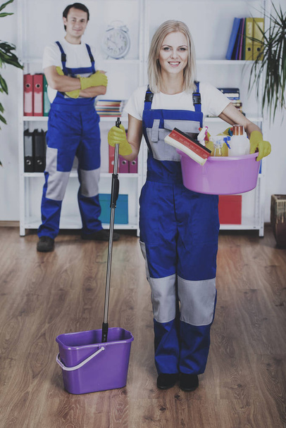 Young couple professional cleaners are cleaning the office - Foto, Bild