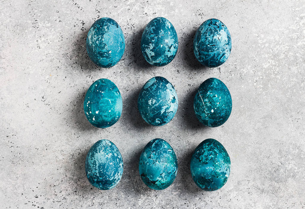 Easter eggs row painted by hand in blue color on light background - Фото, зображення