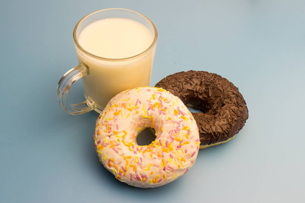 Donuts and milk on a blue background - Фото, зображення