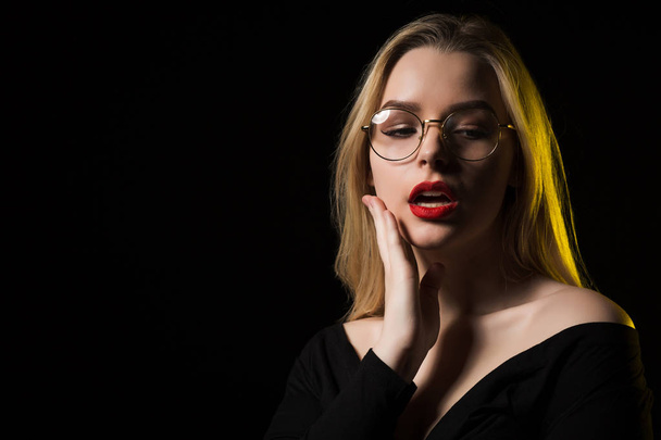 Seductive young woman wearing glasses and trendy blouse, posing  - Фото, зображення