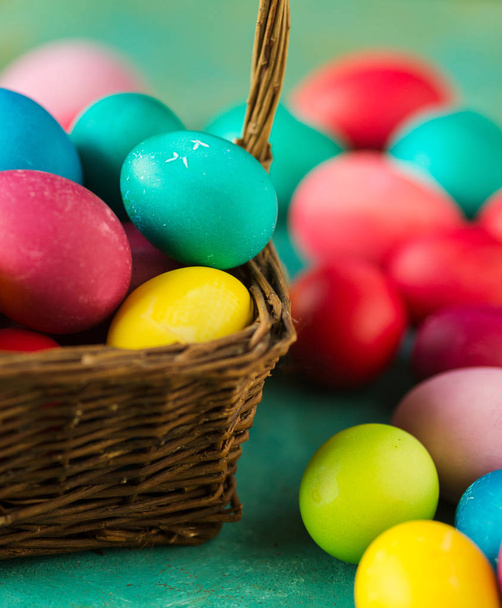Multicolored Easter eggs in basket, close up - Photo, image