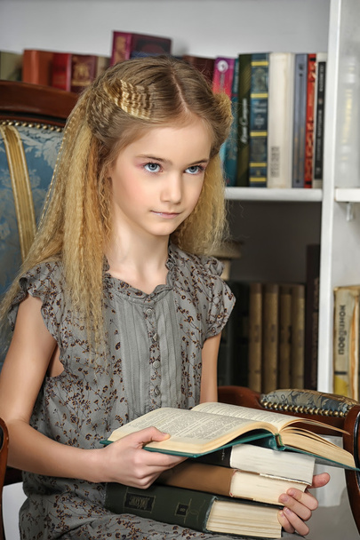 Girl in the library with a stack of books - Photo, image
