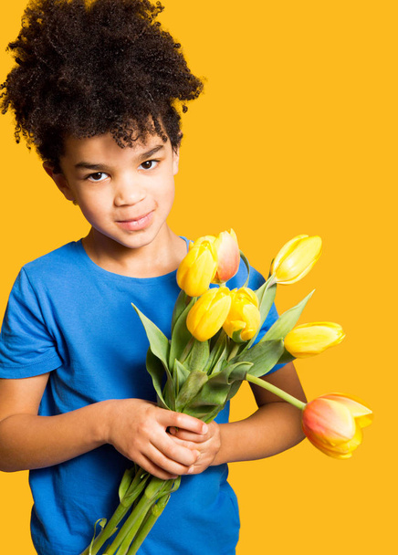 Menino adorável com buquê de tulipas para a mãe
 - Foto, Imagem