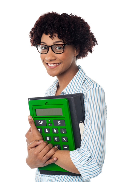 Young businesswoman with calculator and file - Photo, Image
