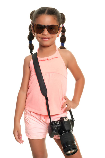 Multiracial small girl with sunglasses and a professional camera - Foto, immagini