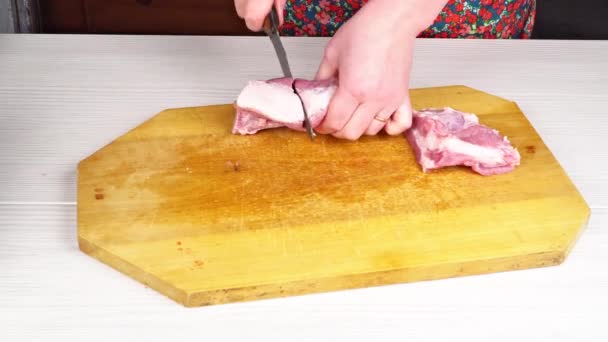 Mulher chef joga carne fatiada em uma tábua de corte na cozinha da casa. Mãos cortando carne fresca, cortando carne em uma placa de cozinha, cortando carne crua. Cozinhar comida em casa
. - Filmagem, Vídeo
