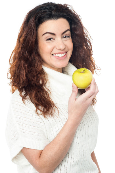 Joyous woman with an apple in hand - Photo, Image