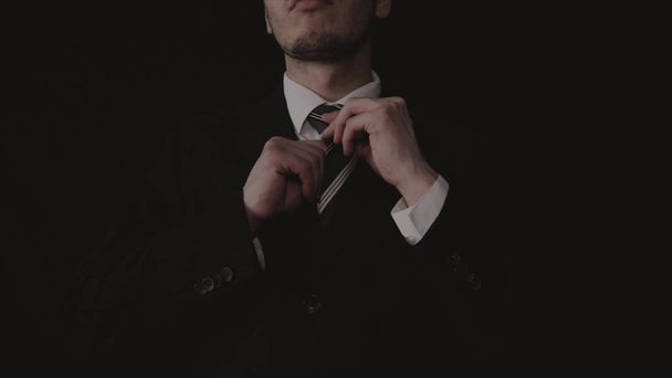 Businessman in suit, black background. - Foto, imagen