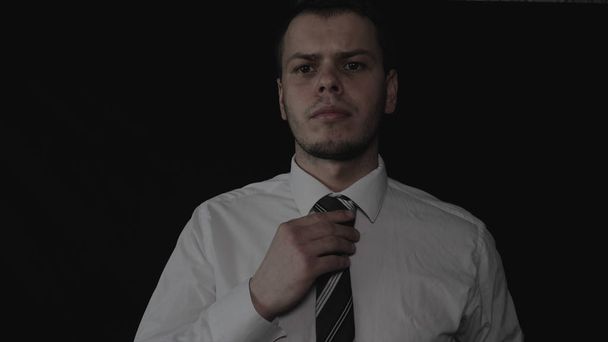Handsome young businessman in white shirt, black background. - Fotografie, Obrázek