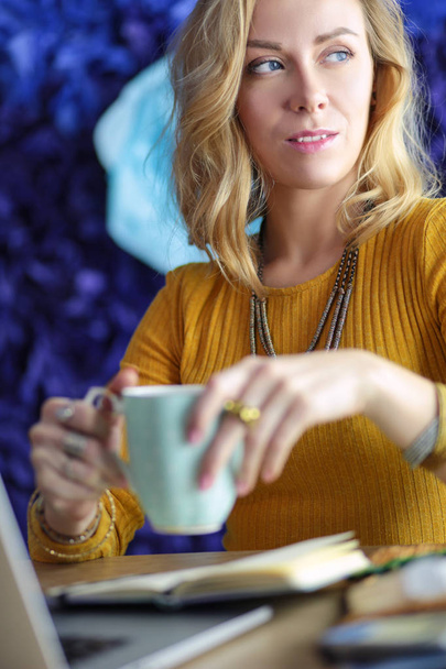 Young woman on a coffee break or enjoying the coffee-break, Using laptop computer - Φωτογραφία, εικόνα