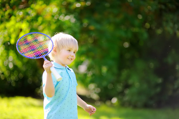 Kid playing badminton in summer park - Photo, image