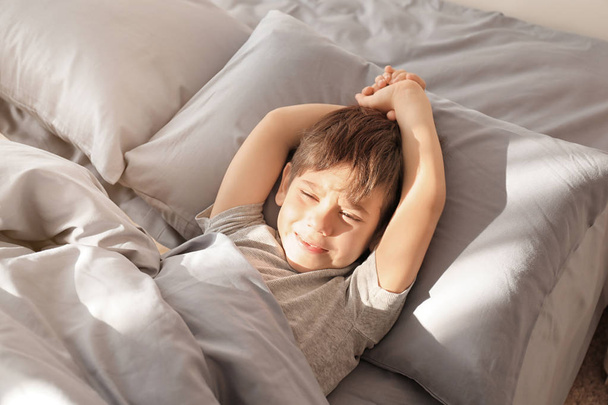 Cute little boy waking up in morning at home - Valokuva, kuva