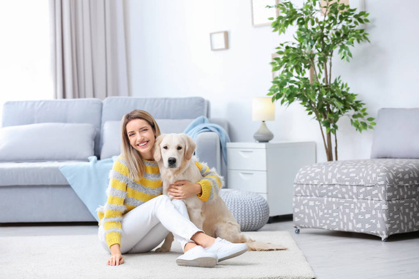 Portrait of happy woman with her dog at home - Foto, Imagen
