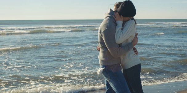 Cool Couple Laughing and hugging In Front Of Beach at beautiful autumn day - Valokuva, kuva