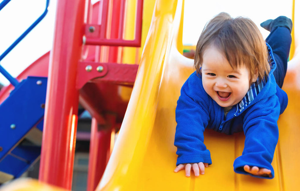 Toddler boy playing on the playground - Foto, imagen