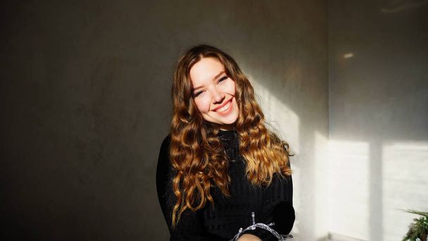 Young Female Smiling, Looking at Camera with curly hair - Photo, Image