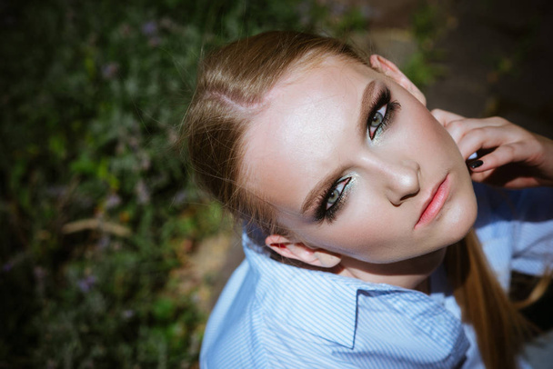 Woman with makeup on young face skin, top view - Fotó, kép