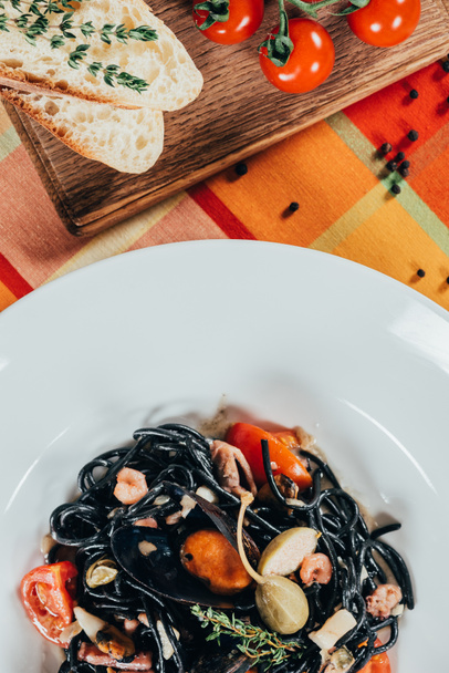top view of spaghetti with cuttlefish ink, squid and mussels with octopus - Photo, Image