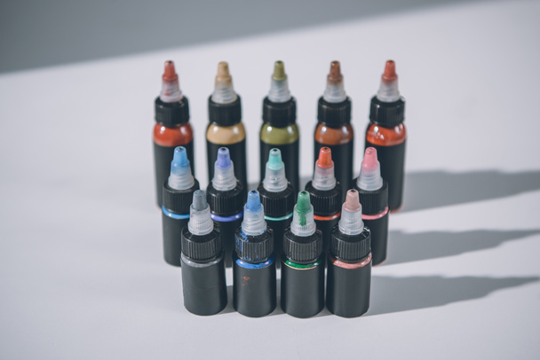 Bottles with colorful tattoo ink in rows - Photo, Image