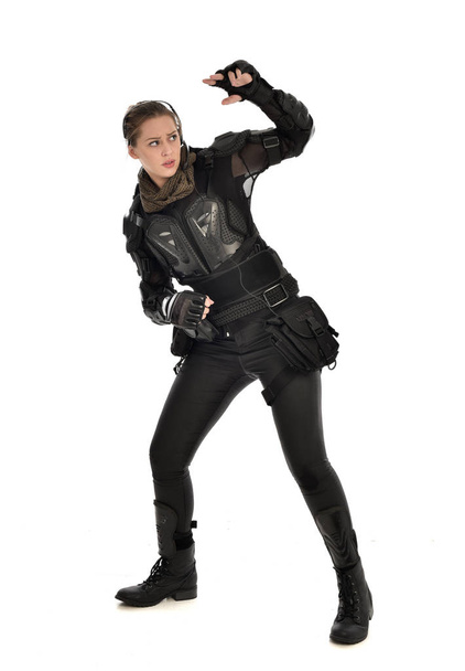 full length portrait of female  soldier wearing black  tactical armour, isolated on white studio background. - Photo, image