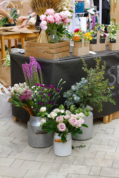 Beautiful flowers in metal vases at market - Zdjęcie, obraz