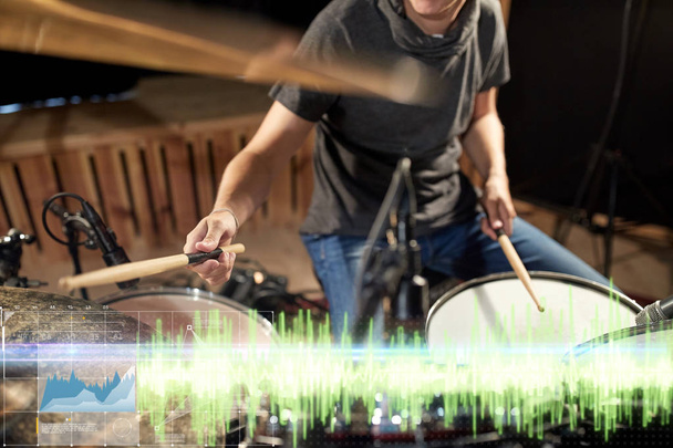 drummer playing drum kit at sound recording studio - Foto, afbeelding