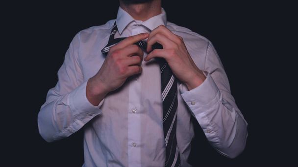 Businessman in white shirt, black background. - Фото, зображення