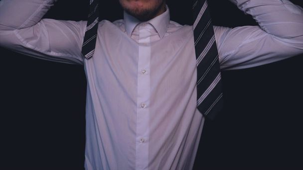 Businessman in white shirt, black background. - Foto, imagen