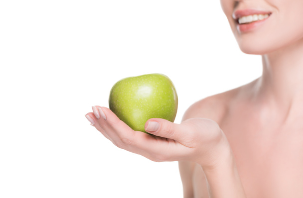 Cropped view of woman with clean skin holding apple isolated on white - Foto, imagen