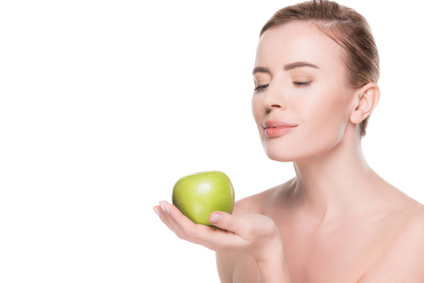 Portrait of woman with clean skin holding apple isolated on white - Photo, Image