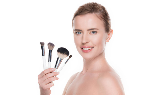 Smiling woman with cosmetic brushes isolated on white - Foto, Imagem