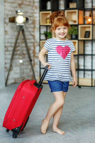 Little happy girl with suitcase. Concept, lifestyle, childhood,  - Fotoğraf, Görsel