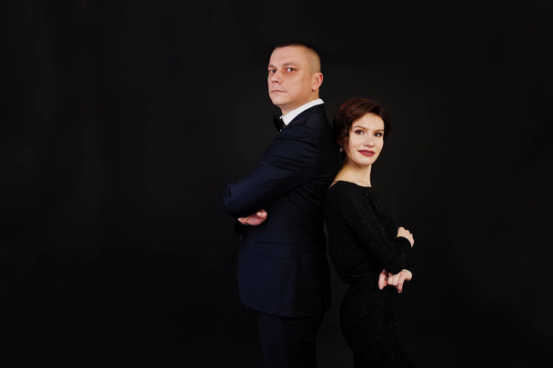 Elegance woman in black evening dress with man in suit posed on  - Фото, зображення