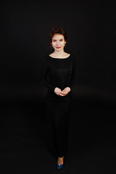 Elegance woman in black evening dress posed on studio isolated o - Φωτογραφία, εικόνα