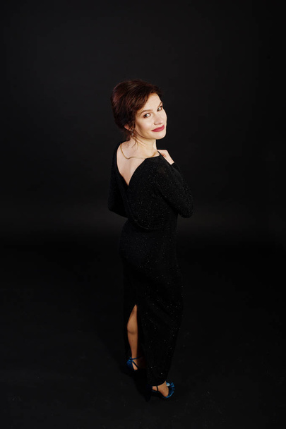 Elegance woman in black evening dress posed on studio isolated o - Valokuva, kuva