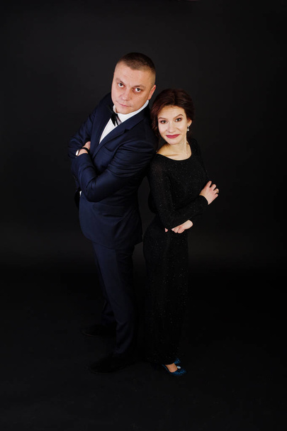 Elegance woman in black evening dress with man in suit posed on  - Фото, изображение