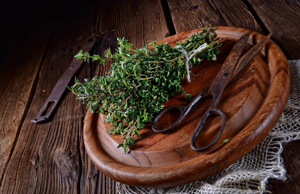 aromatic thyme (Thymus vulgaris) on wooden board - Photo, image