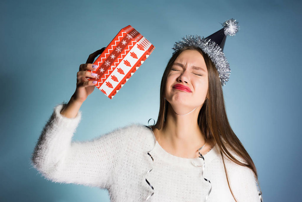 woman is upset with her New Year gift - Zdjęcie, obraz