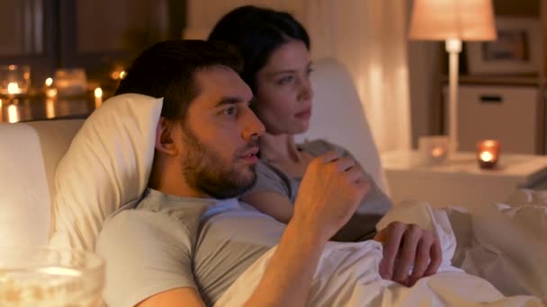 couple watching tv at night at home - Felvétel, videó