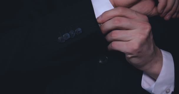 Businessman in suit, black background. - Filmati, video