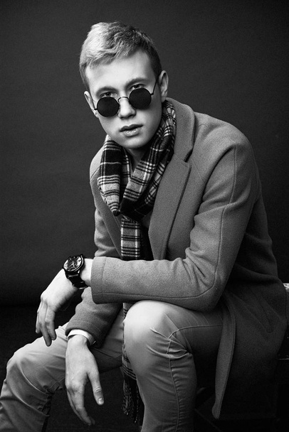 Handsome young man in stylish sunglasses and scarf posing  - Foto, Imagem